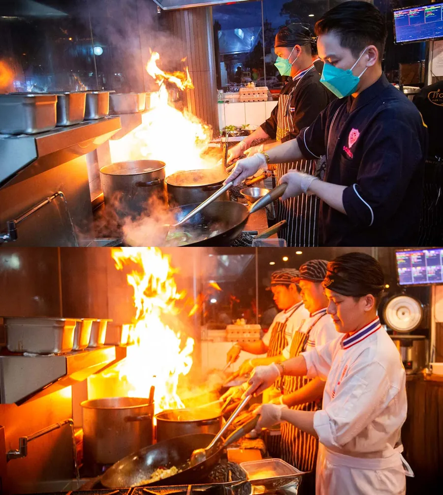 Our chefs cooking with wok fire in the T Top Thai kitchen